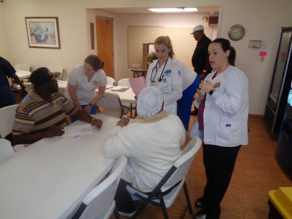 Nursing students speaking to residents