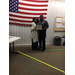 Officer presenting certificate to woman