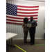 Woman receiving certificate from officer