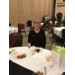 woman smiling at table with desserts