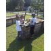 Three kids posing at garden box